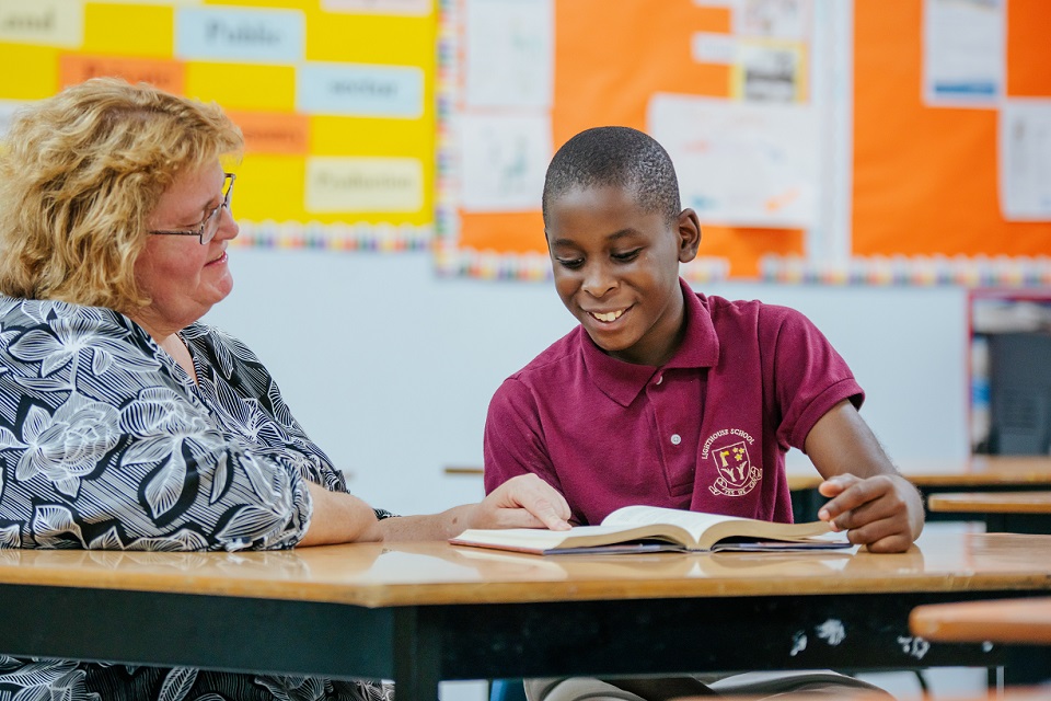 Teacher guiding a student